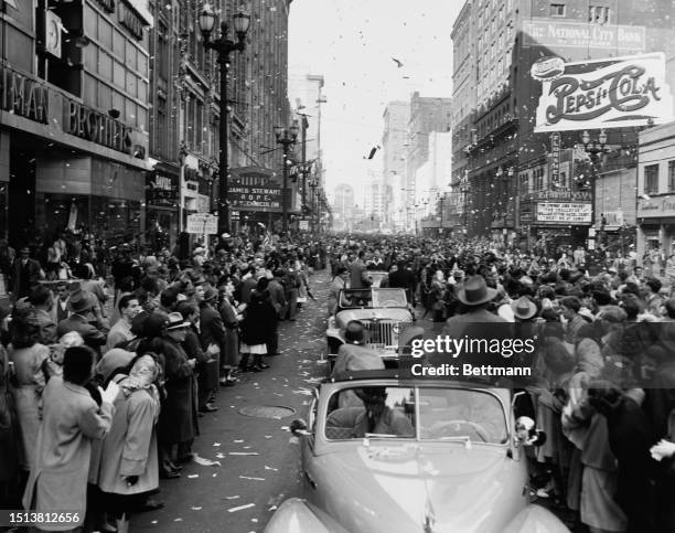 Fans of baseball celebrate the champions Cleveland Indians during the 1948 World Series, as they drive down the street, Cleveland, Ohio, United...