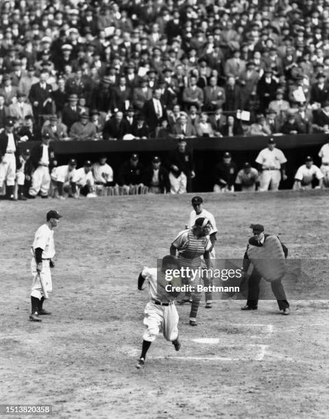 Frankie Crosetti runs from 2nd and scores the New York Yankees third run of the 1st World Series game against the St. Louis Cardinals, New York,...