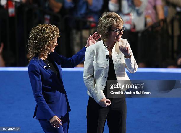 Former U.S. Rep. Gabrielle Giffords walks on stage with Democratic National Committee Chair, U.S. Rep. Debbie Wasserman Schultz during the final day...