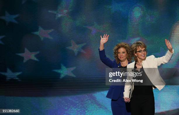 Former U.S. Rep. Gabrielle Giffords waves on stage with Democratic National Committee Chair, U.S. Rep. Debbie Wasserman Schultz during the final day...