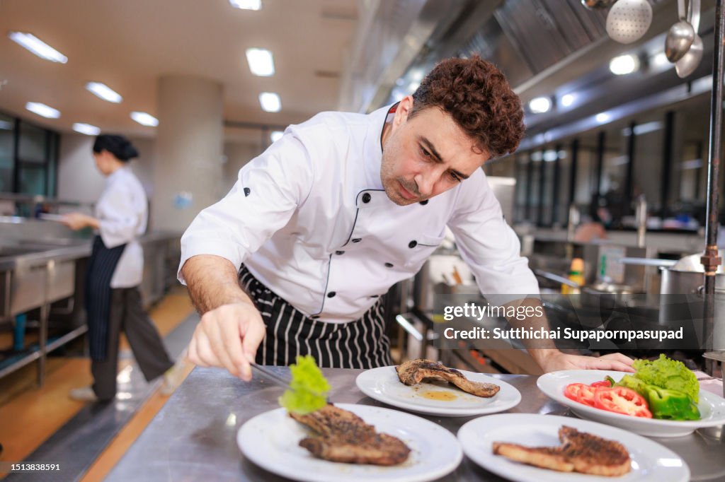 The Art of Presentation: Chef Creates Visual Masterpieces with Food Plate Decor in the Kitchen"