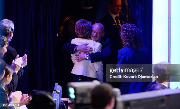 Former U.S. Rep. Gabrielle Giffords hugs her husband former NASA astronaut Mark Kelly stage during the final day of the Democratic National...