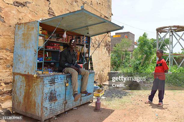 Man who fled the ongoing violence by two rival Sudanese generals, keeps a small shop in the courtyard of the university of Al-Jazira, transformed...