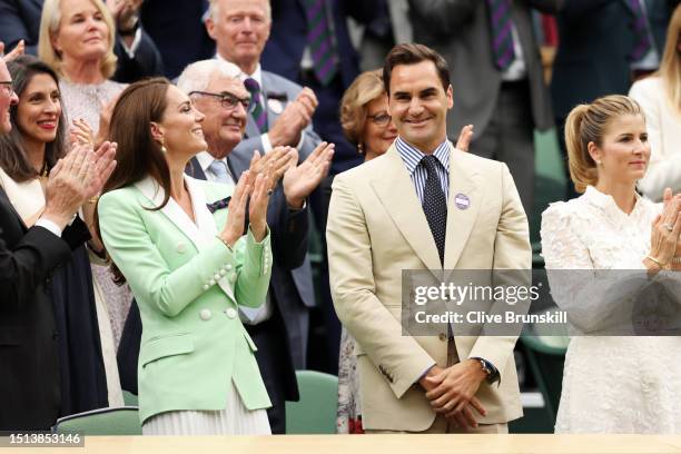 Former Wimbledon Champion, Roger Federer of Switzerland interacts with Catherine, Princess of Wales as he is honoured in the Royal Box prior to the...