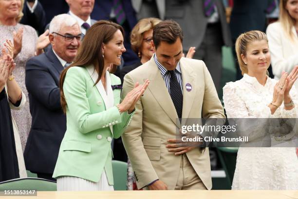 Former Wimbledon Champion, Roger Federer of Switzerland interacts with Catherine, Princess of Wales as he is honoured in the Royal Box prior to the...