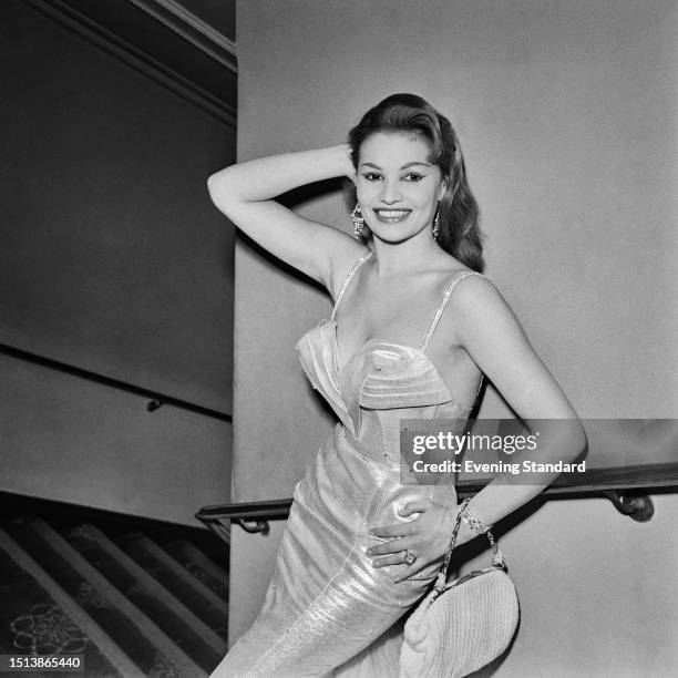 British actress Yvonne Buckingham striking a pose in a shimmering evening dress, November 18th 1958.