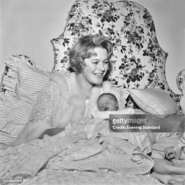 British author Antonia Fraser and baby daughter Flora pictured at home, November 6th 1958.