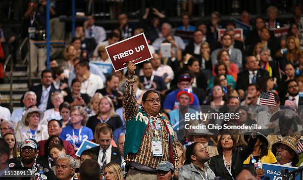 Man holds a sign that says "Fired Up" as Democratic vice presidential candidate, U.S. Vice President Joe Biden speaks on stage during the final day...