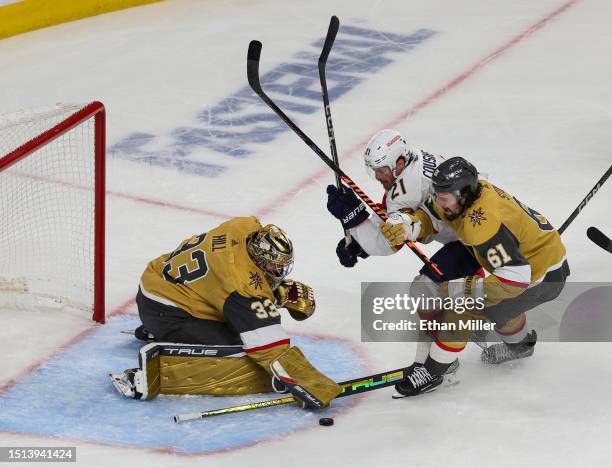 Adin Hill of the Vegas Golden Knights makes a save against Nick Cousins of the Florida Panthers as Mark Stone of the Golden Knights defends in the...