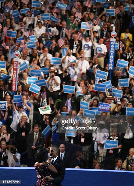 Democratic presidential candidate, U.S. President Barack Obama greets First lady Michelle Obama on stage during the final day of the Democratic...