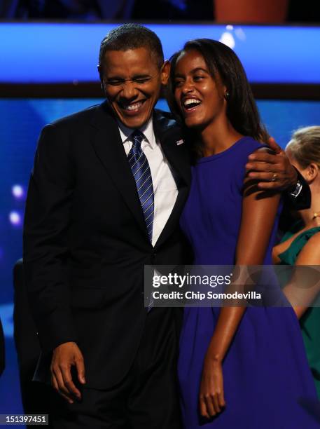 Democratic presidential candidate, U.S. President Barack Obama stands on stage with Malia Obama after accepting the nomination during the final day...