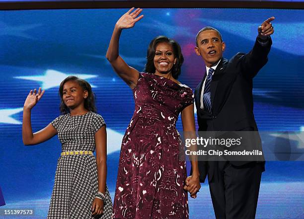 Democratic presidential candidate, U.S. President Barack Obama stands on stage with First lady Michelle Obama and Sasha Obama after accepting the...