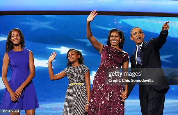 Democratic presidential candidate, U.S. President Barack Obama stands on stage with First lady Michelle Obama and Sasha Obama and Malia Obama after...