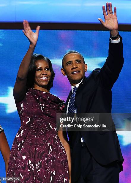 Democratic presidential candidate, U.S. President Barack Obama and First lady Michelle Obama wave on stage after accepting the nomination during the...