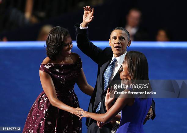 Democratic presidential candidate, U.S. President Barack Obama stands on stage with First lady Michelle Obama and Sasha Obama and Malia Obama after...