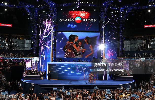 Democratic presidential candidate, U.S. President Barack Obama stands on stage with First lady Michelle Obama and Sasha Obama and Malia Obama after...