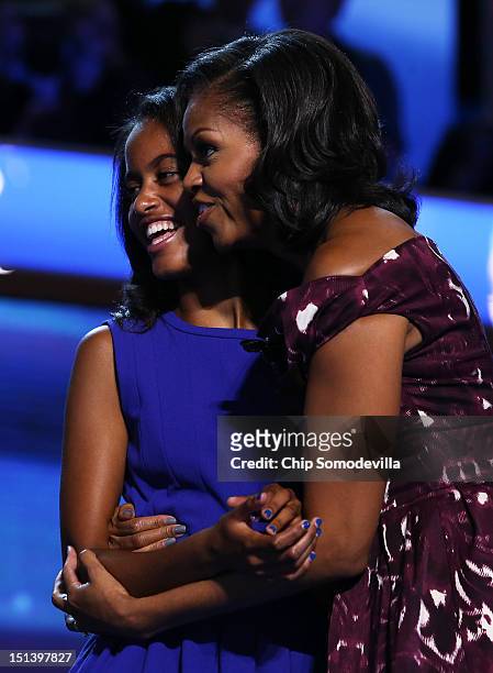 Malia Obama and First lady Michelle Obama stand on stage after Democratic presidential candidate, U.S. President Barack Obama accepted the nomination...