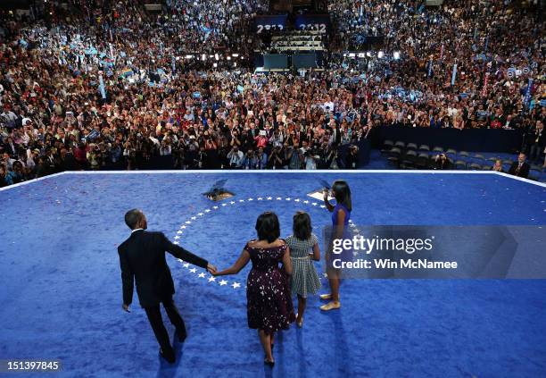 Democratic presidential candidate, U.S. President Barack Obama stands on stage with First lady Michelle Obama and Sasha Obama and Malia Obama after...