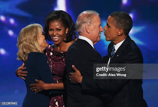 Second lady Dr. Jill Biden hugs First lady Michelle Obama, as Democratic vice presidential candidate, U.S. Vice President Joe Biden greets Democratic...