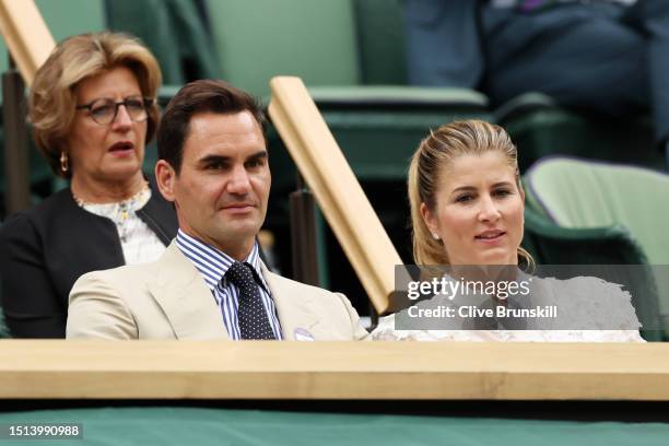 Roger Federer of Switzerland and his wife Mirka Federer watch from the Royal Box during the Women's Singles first round match between Shelby Rogers...