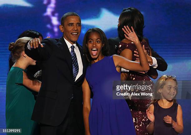 Democratic presidential candidate, U.S. President Barack Obama stands on stage with Malia Obama after accepting the nomination during the final day...