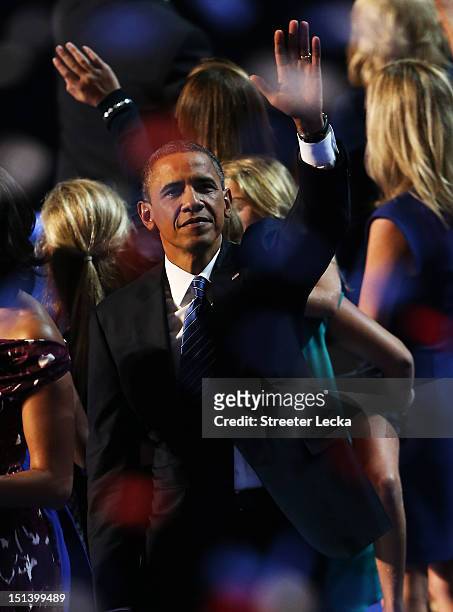 Democratic presidential candidate, U.S. President Barack Obama stands on stage with family and friends after accepting the nomination during the...