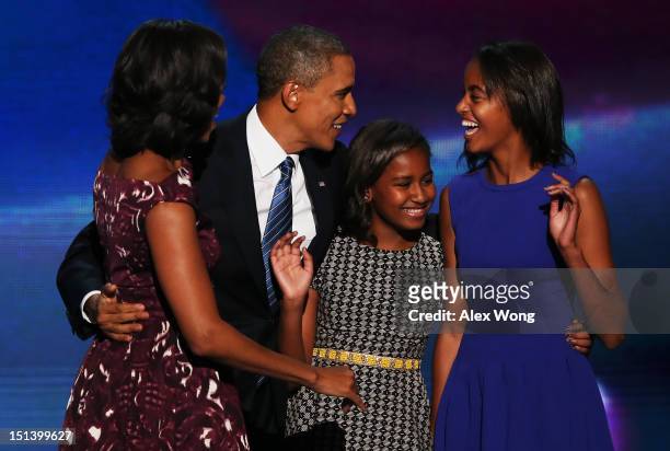 Democratic presidential candidate, U.S. President Barack Obama stands on stage with his family First lady Michelle Obama, Sasha Obama and Malia Obama...