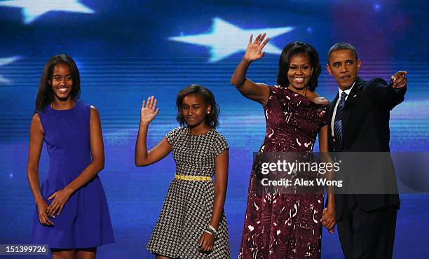 Democratic presidential candidate, U.S. President Barack Obama stands on stage with Malia Obama, Sasha Obama and First lady Michelle Obama after...