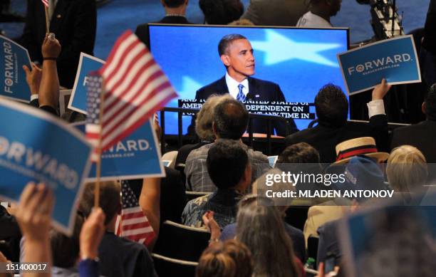 Supporters wave signs and US flags as US President Barack Obama gives his acceptance speech to run for a second term at the Time Warner Cable Arena...