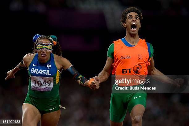 Terezinha Guilhermina of Brazil and her guide Guilherme Soares de Santana win in the Women's 100m - T11on day 7 of the London 2012 Paralympic Games...