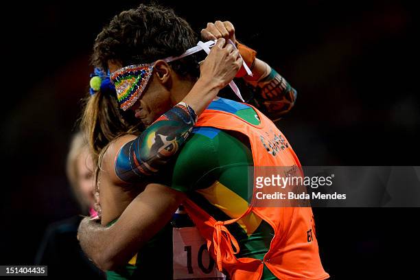 Terezinha Guilhermina of Brazil and her guide Guilherme Soares de Santana celebrate a victory and the gold medal in the Women's 100m - T11on day 7 of...