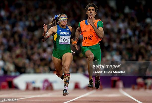 Terezinha Guilhermina of Brazil and her guide Guilherme Soares de Santana compete in the Women's 100m - T11on day 7 of the London 2012 Paralympic...