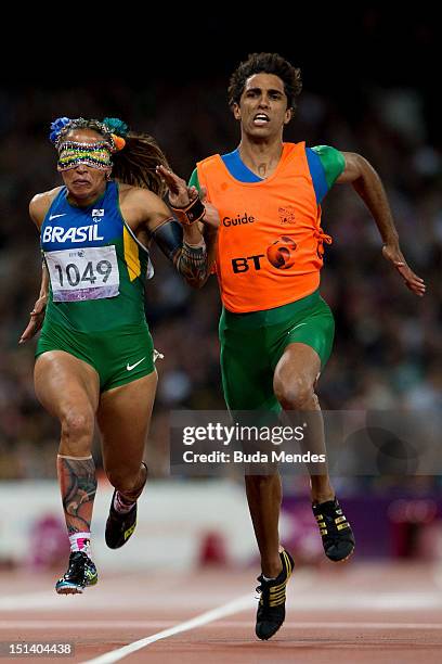 Terezinha Guilhermina of Brazil and her guide Guilherme Soares de Santana compete in the Women's 100m - T11on day 7 of the London 2012 Paralympic...