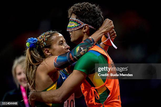 Terezinha Guilhermina of Brazil and her guide Guilherme Soares de Santana celebrate a victory and the gold medal in the Women's 100m - T11on day 7 of...