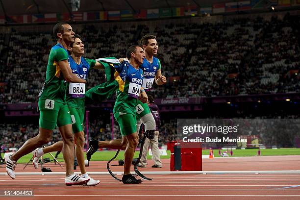 Emicarlo Souza, Yohansson Nascimento, Antonio Souza and Alan Fonteles Cardoso Oliveira celebrate after the Men's 4x100m relay T42/T46 Final on day 7...