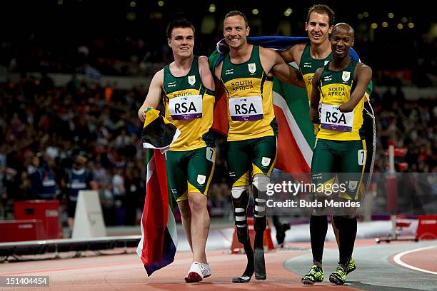 Zivan Smith, Oscar Pistorius, Arnu Fourie and Samkelo Radebe of South Africa pose after victory in the Men's 4x100m relay T42/T46 final on Day 7 of...