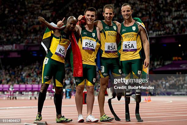 Zivan Smith, Samkelo Radebe, Arnu Fourie and Oscar Pistorius, of South Africa pose after victory in the Men's 4x100m relay T42/T46 final on Day 7 of...