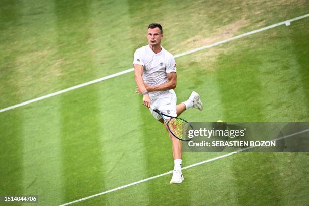 Hungary's Marton Fucsovics returns the ball to Russia's Daniil Medvedev during their men's singles tennis match on the sixth day of the 2023...