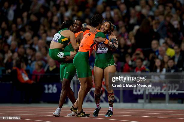 Bronze medallists Jhulia Santos of Brazil and guide Fabio Dias de Oliveira Silva and gold medallists Terezinha Guilhermina of Brazil and guide...