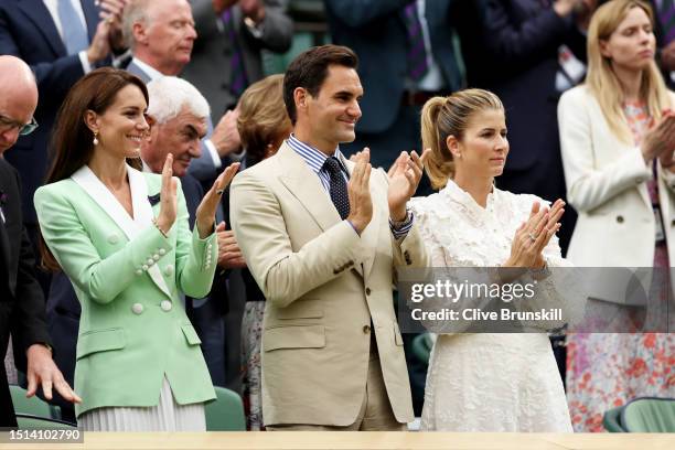 Catherine, Princess of Wales, former Wimbledon Champion, Roger Federer of Switzerland and his wife Mirka Federer applaud from the Royal Box during...