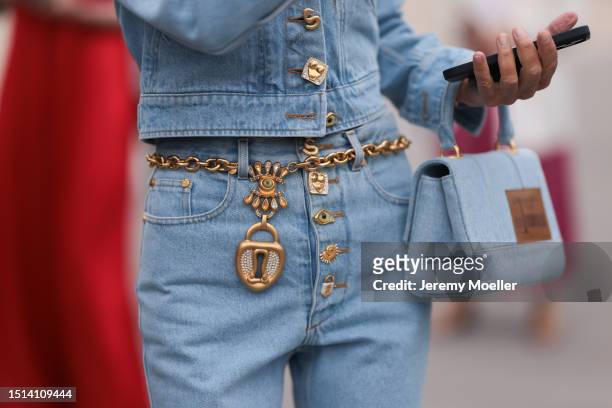 Anna Dello Russo seen outside Schiaparelli wearing Schiaparelli jeans jacket, Schiaparelli gold belt , Schiaparelli pari of jeans and a Schiaparelli...