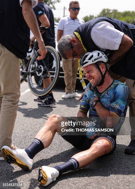Astana Qazaqstan Team's British rider Mark Cavendish receives medical attention after suffering a crash during the 8th stage of the 110th edition of...