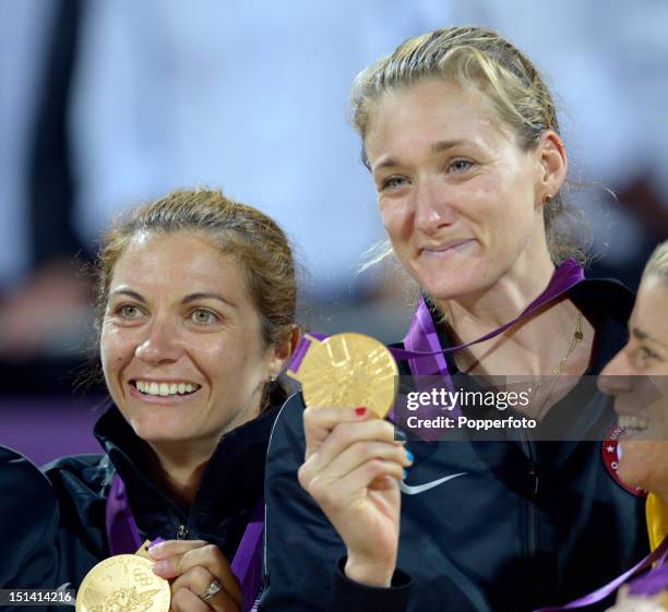 Gold medallists Misty May-Treanor and Kerri Walsh Jennings of the United States celebrate on the podium during the medal ceremony for the Women's...