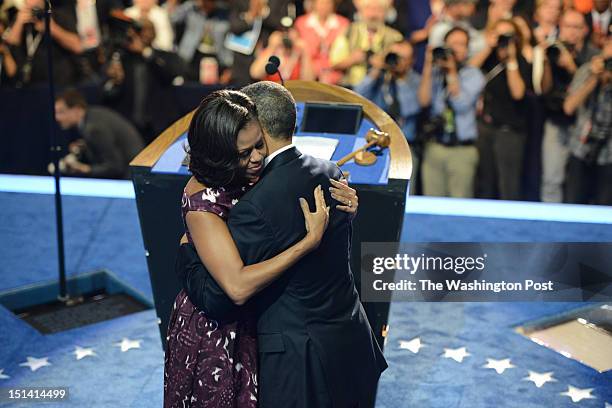 First lady Michelle Obama hugs President Barack Obama after introducing him before his nomination acceptance speech during the final night of the...