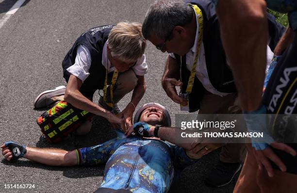 Astana Qazaqstan Team's British rider Mark Cavendish receives medical attention after suffering a crash during the 8th stage of the 110th edition of...