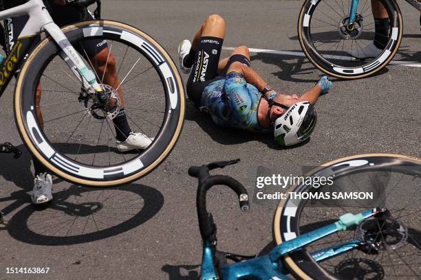 Astana Qazaqstan Team's British rider Mark Cavendish lies on the ground after suffering a crash during the 8th stage of the 110th edition of the Tour...