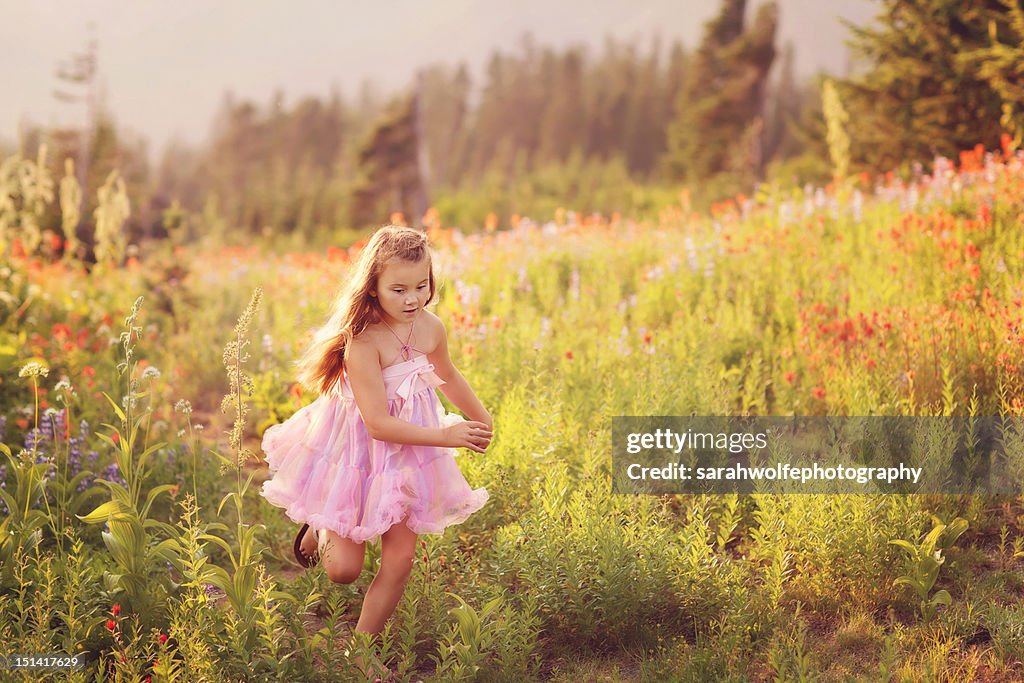 Young girl running through a field