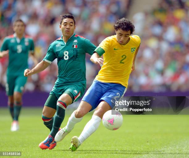Rafael of Brazil with Marco Fabian of Mexico during the Men's Football Final between Brazil and Mexico on Day 15 of the London 2012 Olympic Games at...
