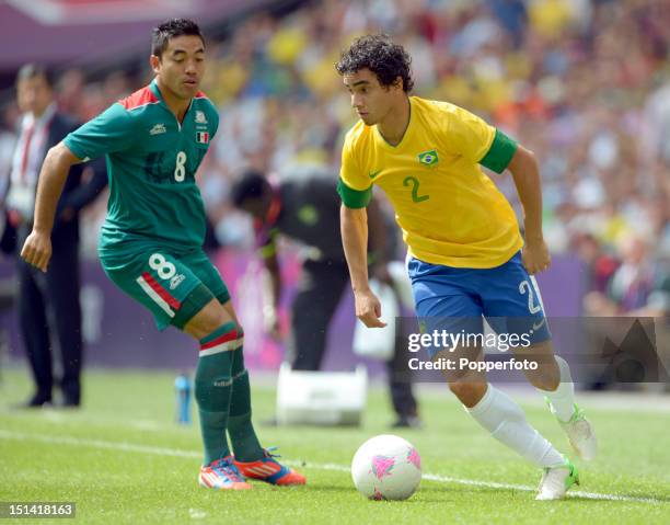 Rafael of Brazil with Marco Fabian of Mexico during the Men's Football Final between Brazil and Mexico on Day 15 of the London 2012 Olympic Games at...