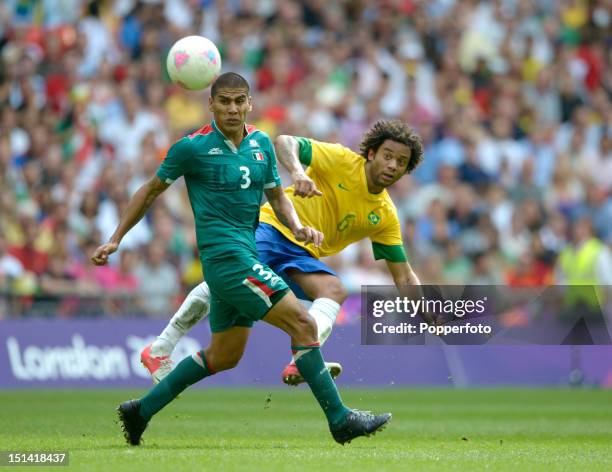 Marcelo of Brazil with Carlos Salcido of Mexico during the Men's Football Final between Brazil and Mexico on Day 15 of the London 2012 Olympic Games...